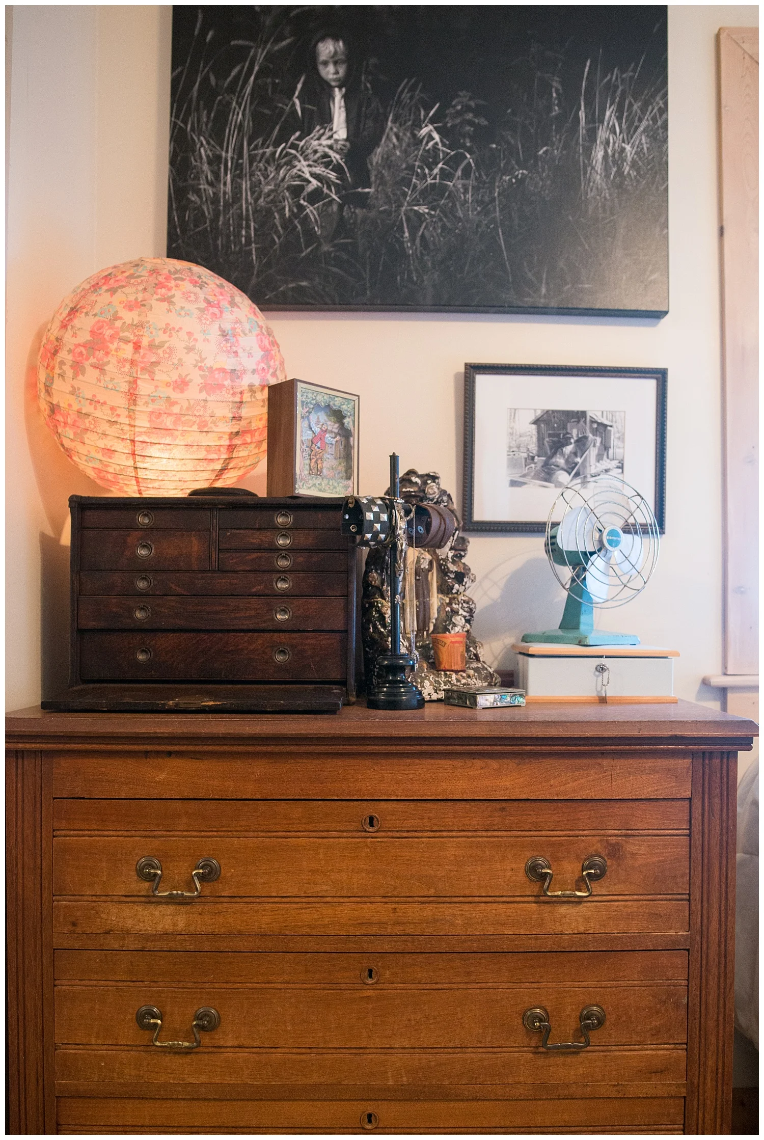 There above the beautiful wooden dresser is a younger Tharin walking through a field. The Chinese lantern is one of the first things Tytia bought from Fresh Digs. It's always fun to see what she picks out from both the new stuff and the vintage stuff.