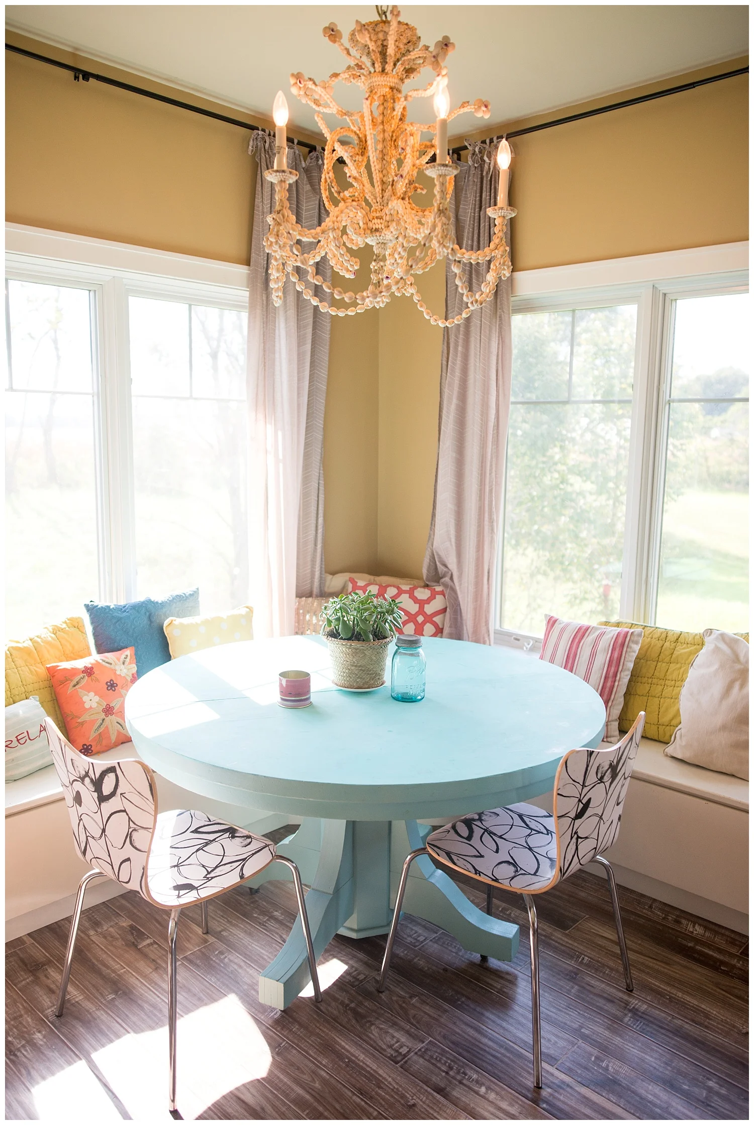 Check out the shell chandelier - it's easy to see why it's one of her favorite things. The blue table below is one she painted herself. And when you walk in her home it always smells nice. On photo shoot day she was burning a few of the soy Illume candles that we carry in the shop.