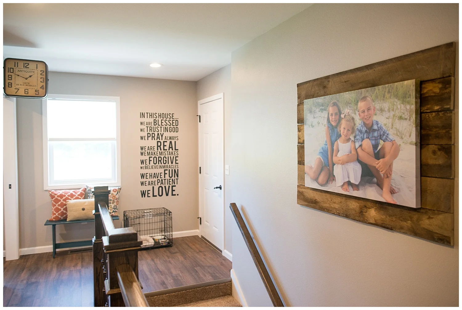The double-sided clock from Fresh Digs hangs at the end of the lockers and leads into the laundry room. Elizabeth bought 8' boards and cut them into planks to make this great family photo feature on the right. And there on the wall is the family's philosophy.
