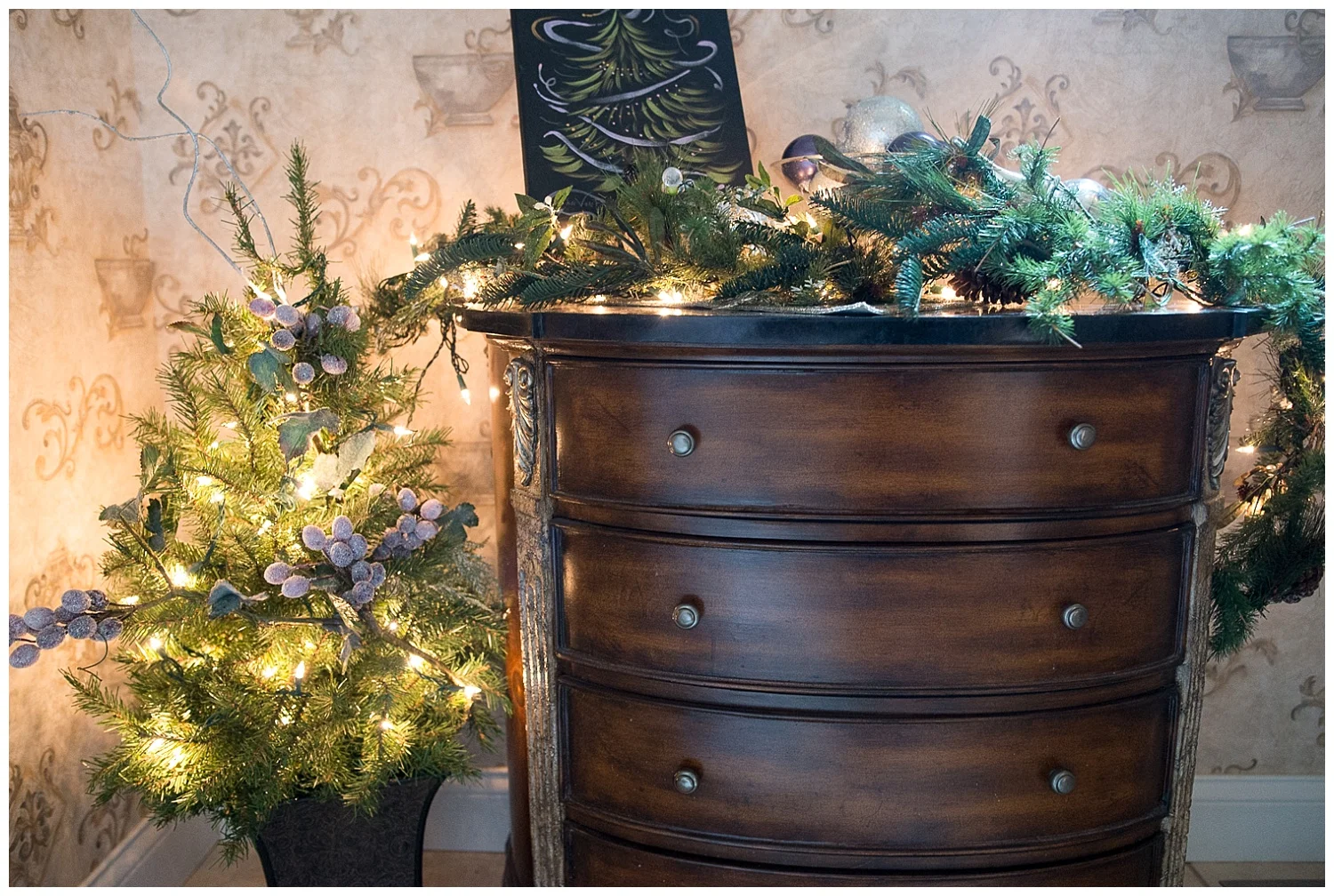 Even the bathroom has Christmas cheer. She was given the Jan VonBokel Christmas tree painting and worked it into her dresser decor.
