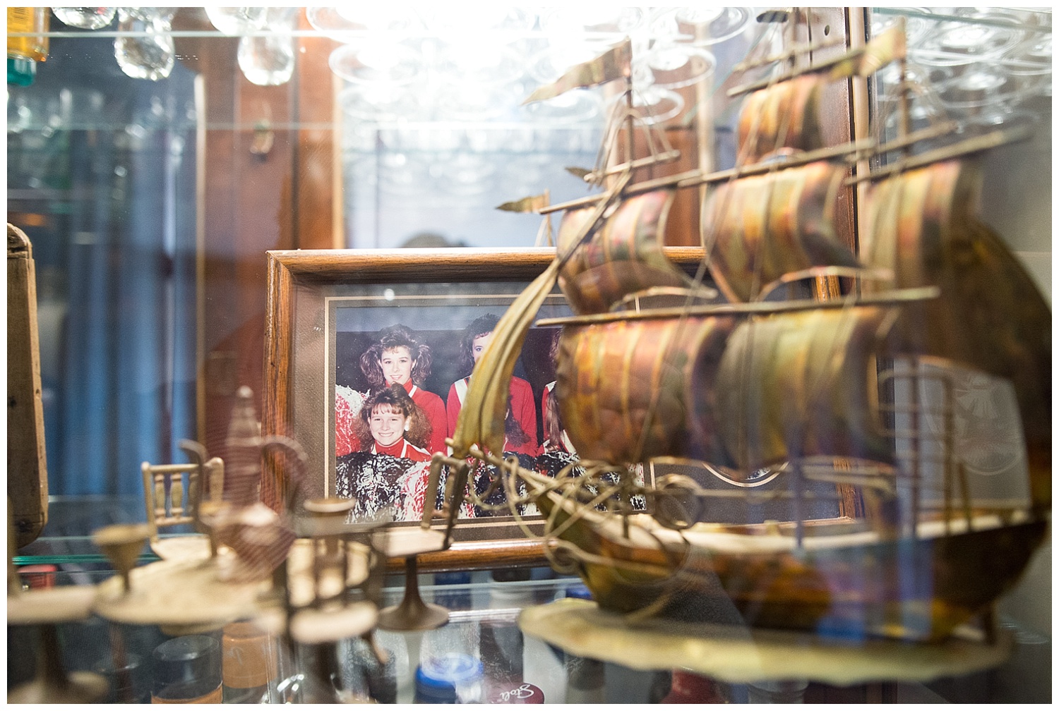 The hutch-cum-bar is surrounded by meaningful family pictures, each one telling a story and the brass ship is one of Ray's favorite things. Chandra, is that you back there? : )