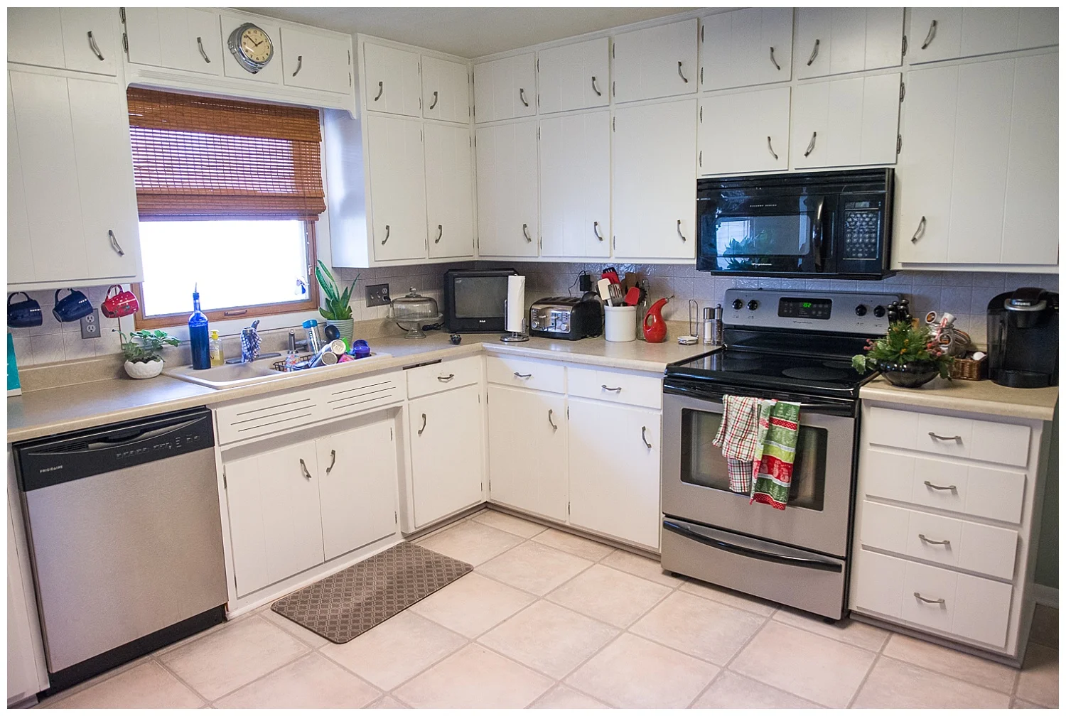 This gleaming kitchen is thanks to spotless white painted kitchen cupboards. And they are thanks to a team of family members pitching in to get them painted in the week before the Stortzums moved in.