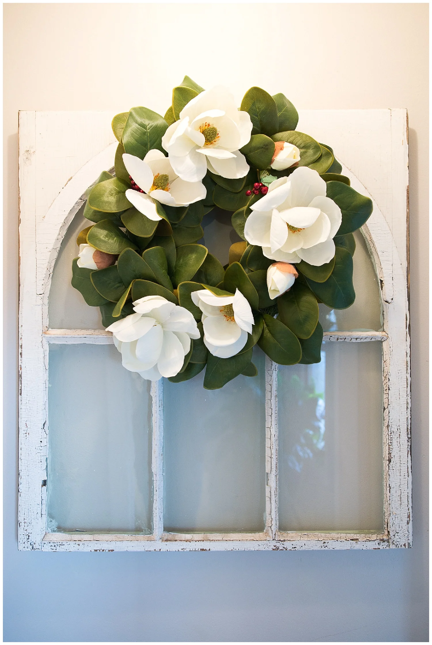 Monica's mom is a great shopper. She scored a number of these windows at the St. Francis auction held during the town's terquasquicentennial (see what I mean about close community?) celebration. These windows were once in the Monastery Museum. It looks beautiful on the wall with the magnolia wreath. 