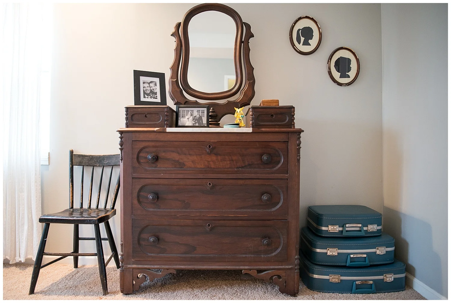 And she nabbed this other beautiful dresser out of her parent’s basement. She ordered the stack of suitcases from Etsy for her birthday and you guessed it, she made the silhouettes. The hardest part, she says, was getting the girls to stand still. Yes there is a child missing.