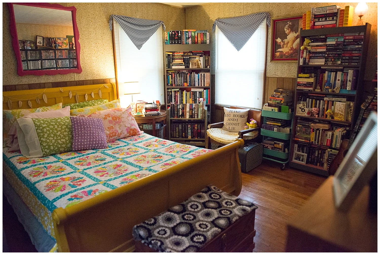 Their bedroom reminds me of the Berenstain Bears book where the kids split their room down the middle, except these two get along. Bri’s got her side filled with books, books and more books and he’s got his filled with Masters of the Universe action figures, media of all kinds and vintage pop culture memorabilia. But they meet in the middle under the gorgeous quilt that Bri’s mom, Kathy, made plus pillows covered in Bri’s beloved vintage pillowcases. The picture of the girl reading reminds Aaron of their daughter Hannah. 