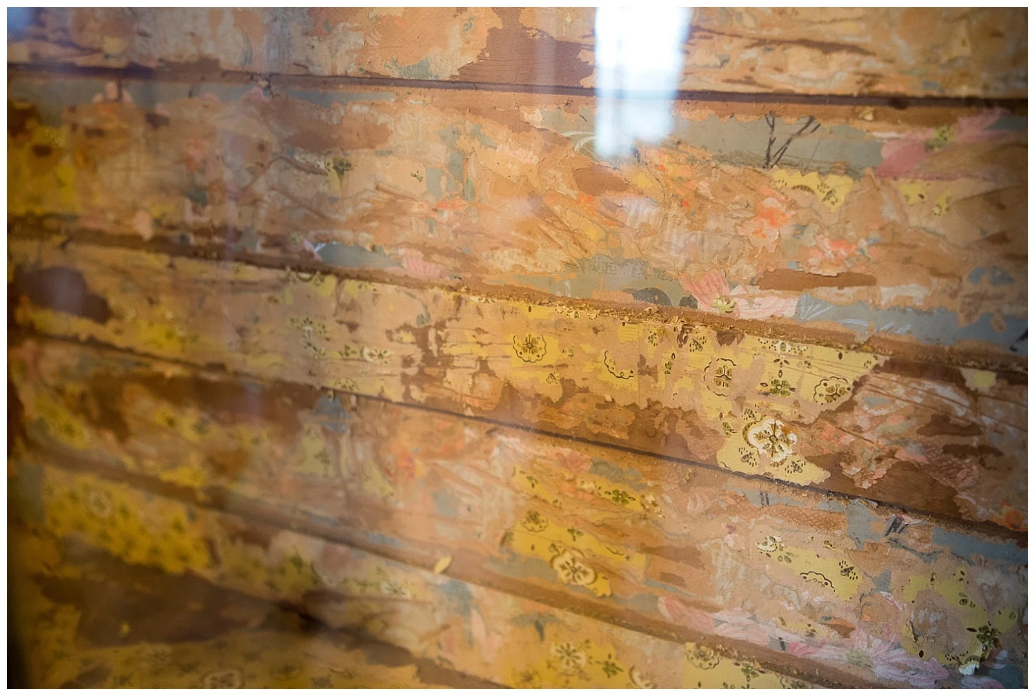 Layers of old wallpaper on wood they were stripping for a customer. Rick says it's since been stripped and the wood underneath is even more beautiful. 