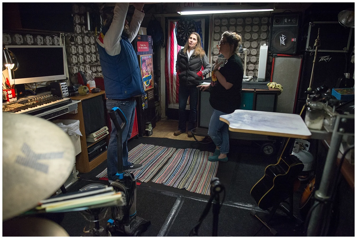 Ever resourceful as he is, Bath & Body Works candle packaging provides soundproofing on his walls. Here are Bri (far right) and I listening to him talk about the fire. Note Bri's fabulous felted wool slippers handmade by her sister, Amber.