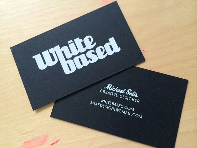  1/1 screen printed business cards. White ink on 130lb. epic black neenah paper with an eggshell finish. 