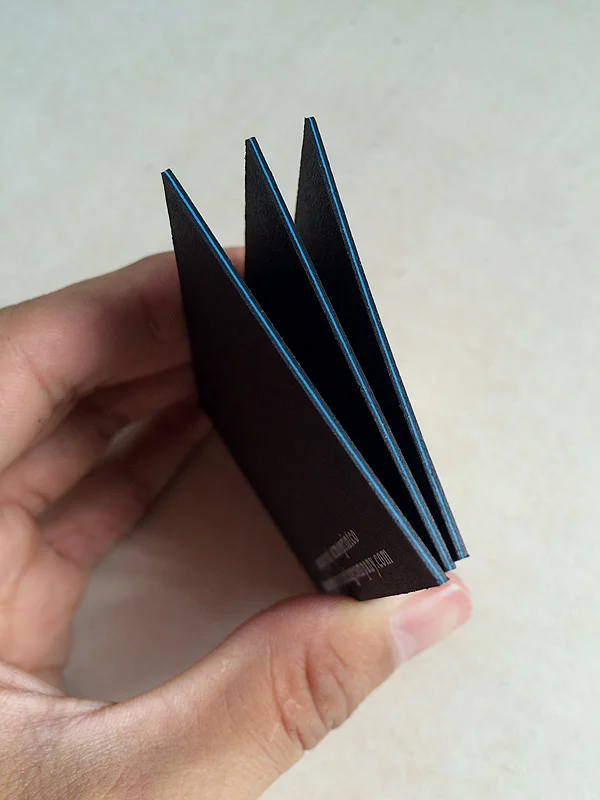 bright blue neenah paper sandwiched in between epic black neenah paper