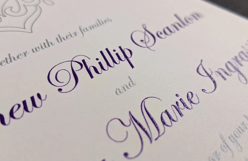 1 color purple raised thermography and 1 color flat metallic silver offset.