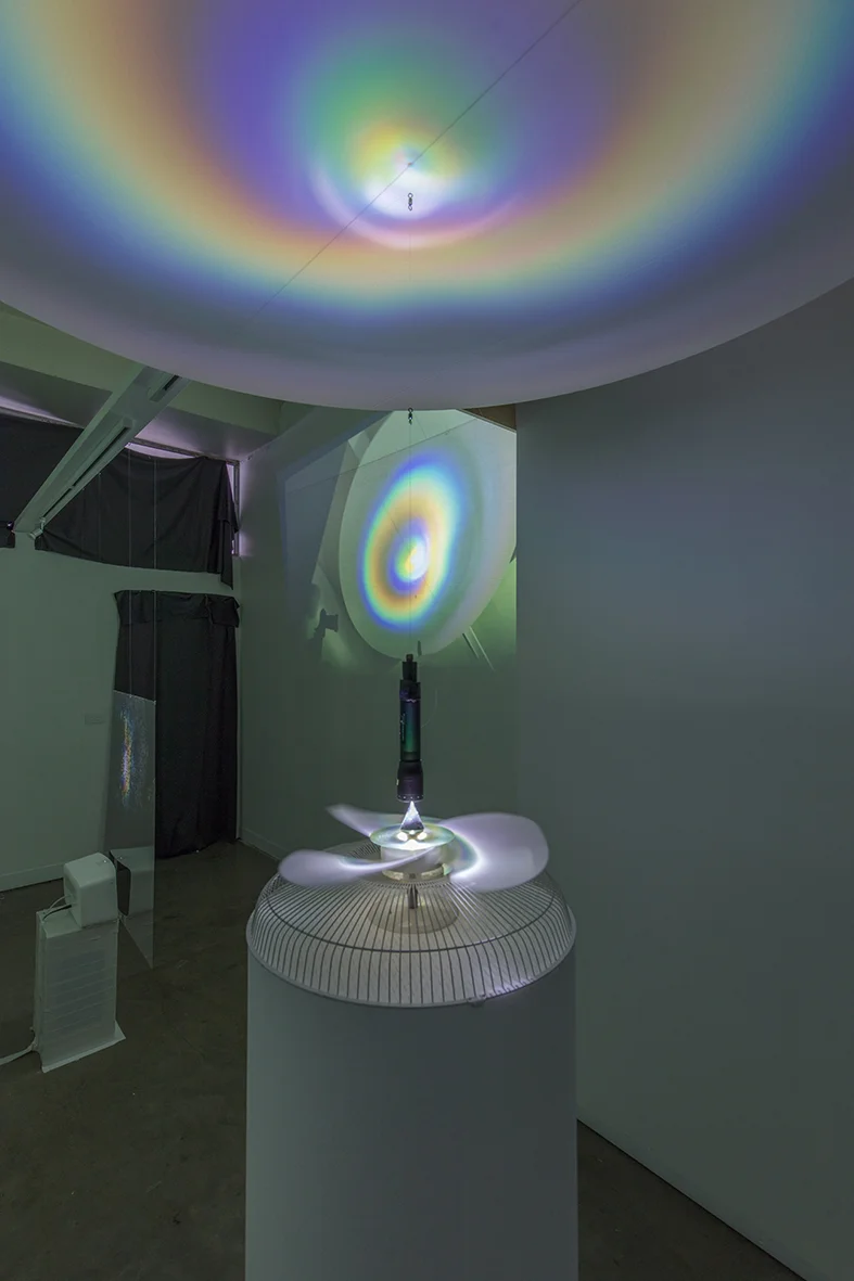 installation view, 2018 - speaker, clear film, video projection (background) kinetic sculpture object foreground