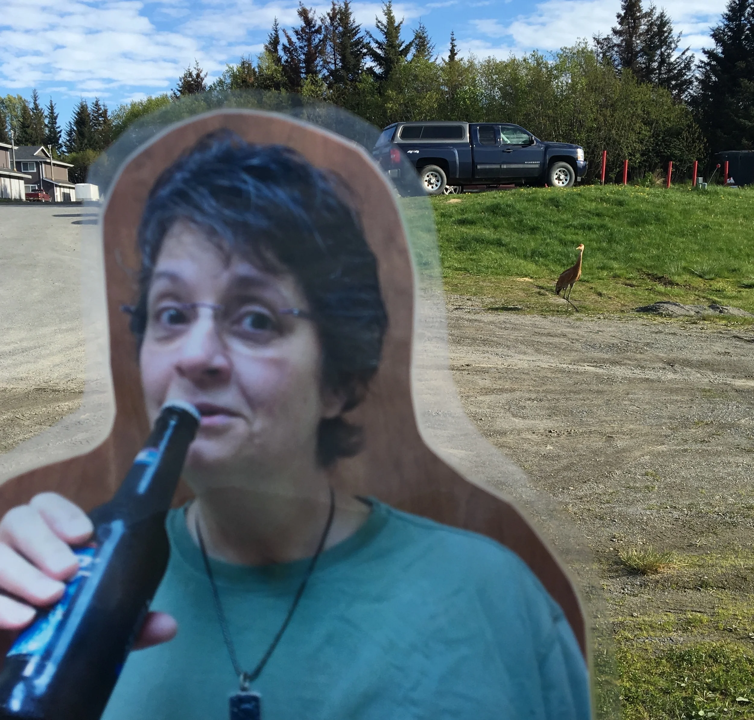 Flat Michelle kicking on back with an obliging sandhill crane in the background. 