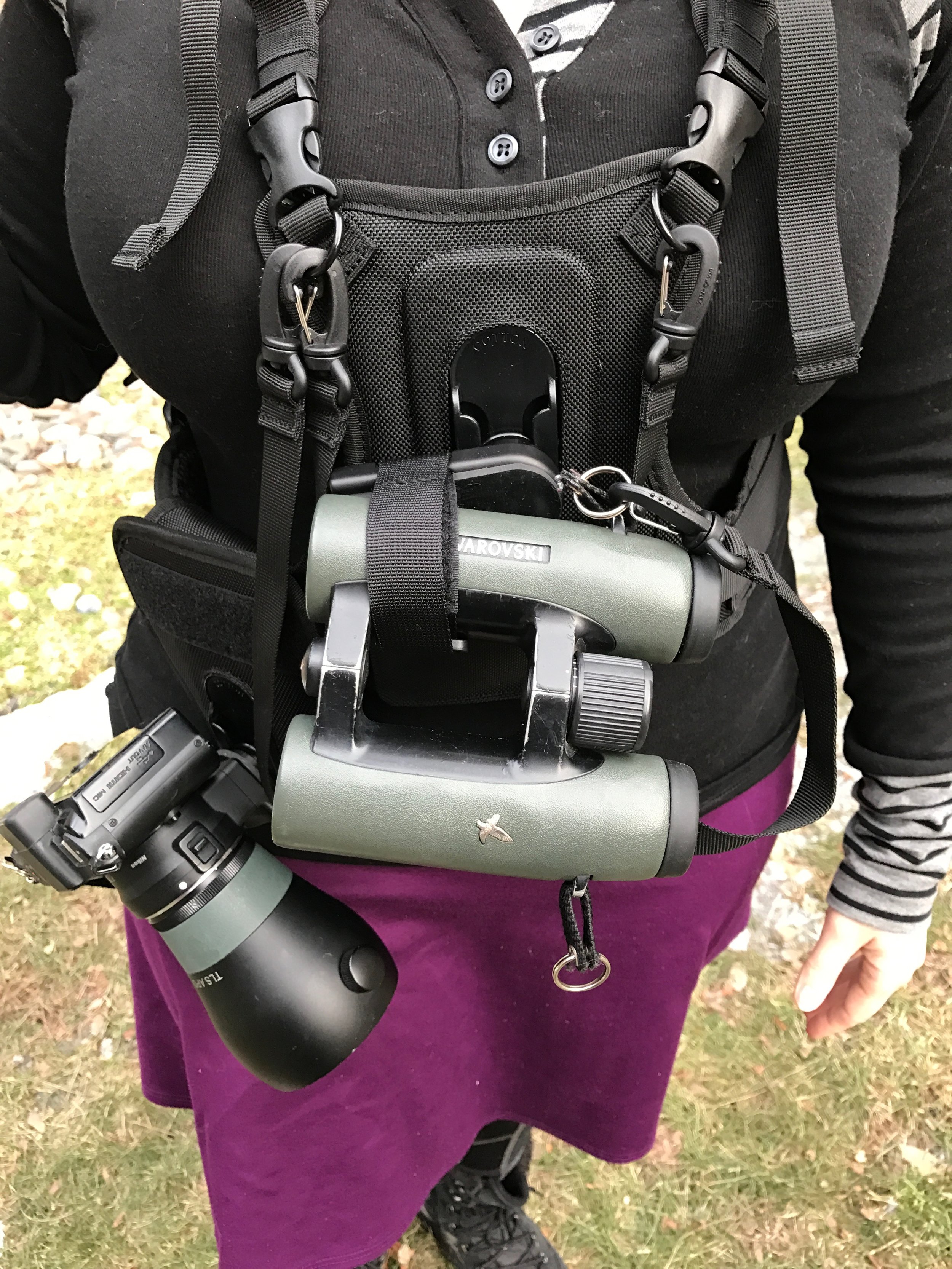 You'll note there are straps with clips to help secure your camera and binoculars to the vest should they become dislodged from the vest, preventing them from dropping to the ground. I like how the binoculars are flat against the chest and don't flop around. I'm using 8x32 ELs which are compact and lightweight, it might be a different story with larger barrel binos.
