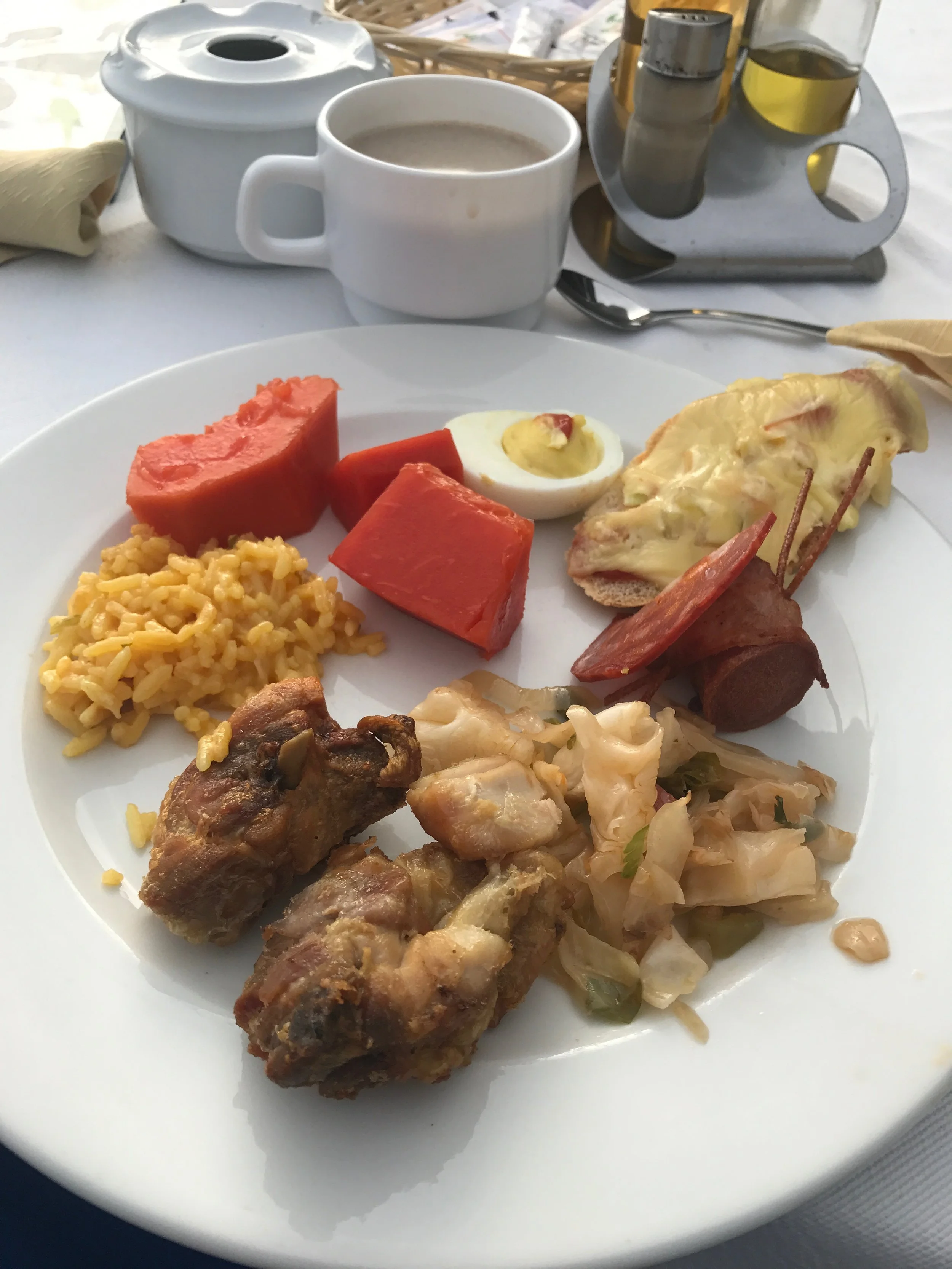 Sampling of the breakfast buffet at my Havana hotel: papaya, cheesy rice, friend chicken, suateed cabbage, hot dog wrapped in pepperoni, deviled egg, baguette with melted cheese. There all kinds of breads and roll to choose from as well. 