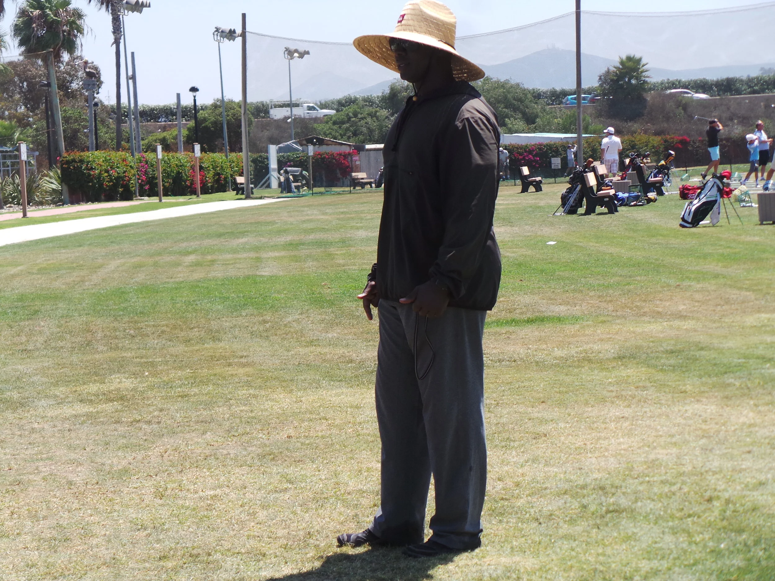Coach Milo watching group of teenagers warm up for practice.