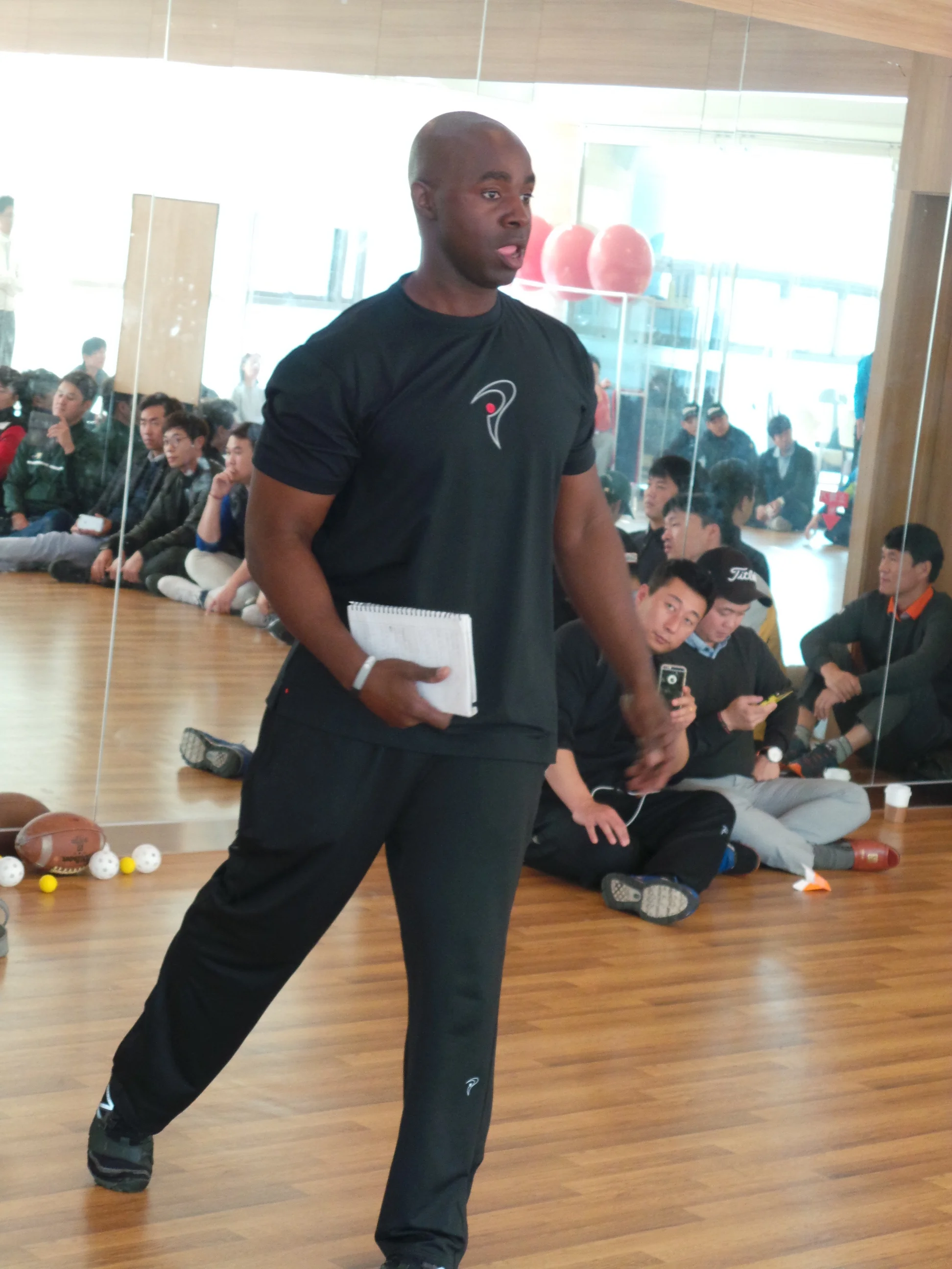 Coach Milo teaching golf professionals at a seminar in South Korea.