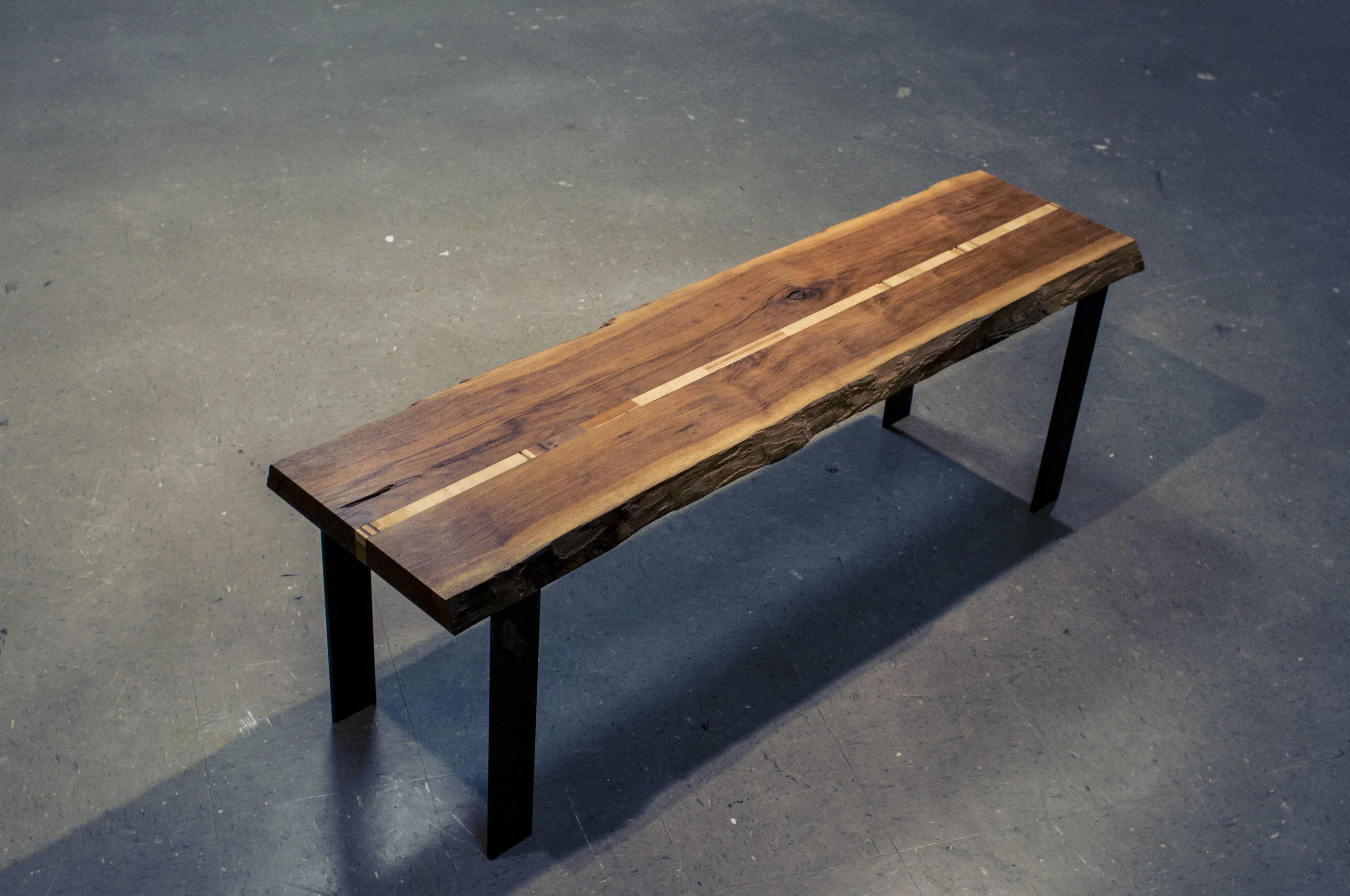 Bench-Walnut, mixed woods and steel. 2012. This Bench was a final project for a woodworking class, and was purchased by the Grove House at Pitzer College. I am humbled to have it residing here among other 80 year-old craftsman style furniture, and be used by anyone willing to sit down and give the adjacent piano a try.