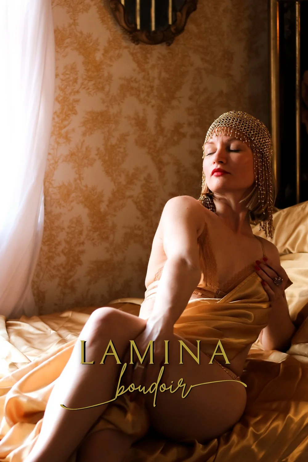 Golden goddess relaxes into her most empowered self during a photo shoot at LAMINA Boudoir private studio in Indianapolis, Indiana.