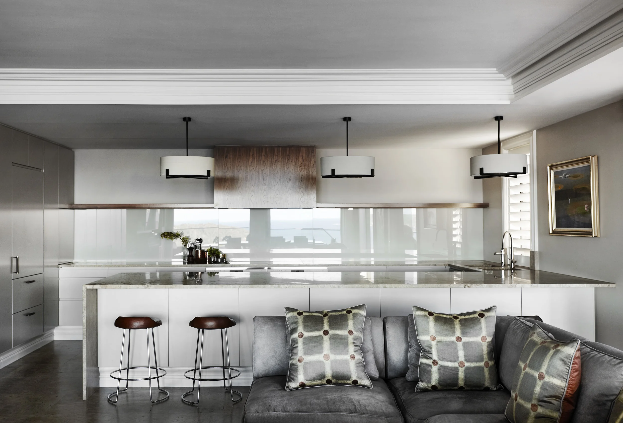 The kitchen in our Stanley Avenue project is perfect for entertaining with seating at the breakfast bar allowing for two-way conversation, plenty of bench space for prep and plating, stone flooring throughout the kitchen and living creates a cohesive and larger sense of space, and last but not least a good exhaust is a must!