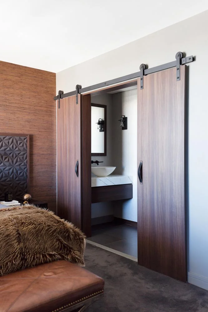 Chocolate coloured wood makes a bold statement moving from the master bedroom to master bath in our Bourke Street 2 project. Although very solid and heavy, the use of timber adds a naturally rich and warm texture to the spaces, softening the masculine lines.
