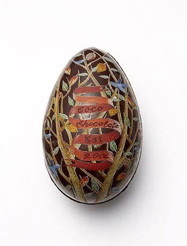 A Coco Chocolate organic chocolate egg painted with cacao butter artwork simply melts away as the chocolate is eaten.