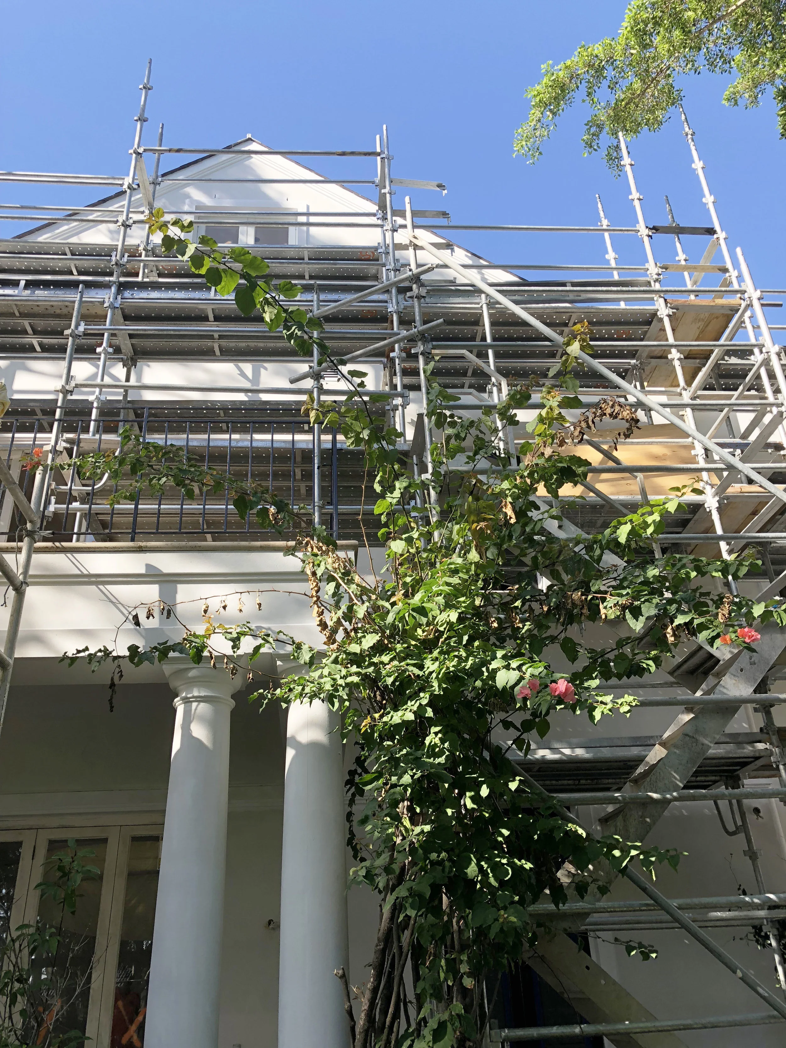 We are updating the outdated creamy yellow paint colour with a modern black and white exterior scheme.