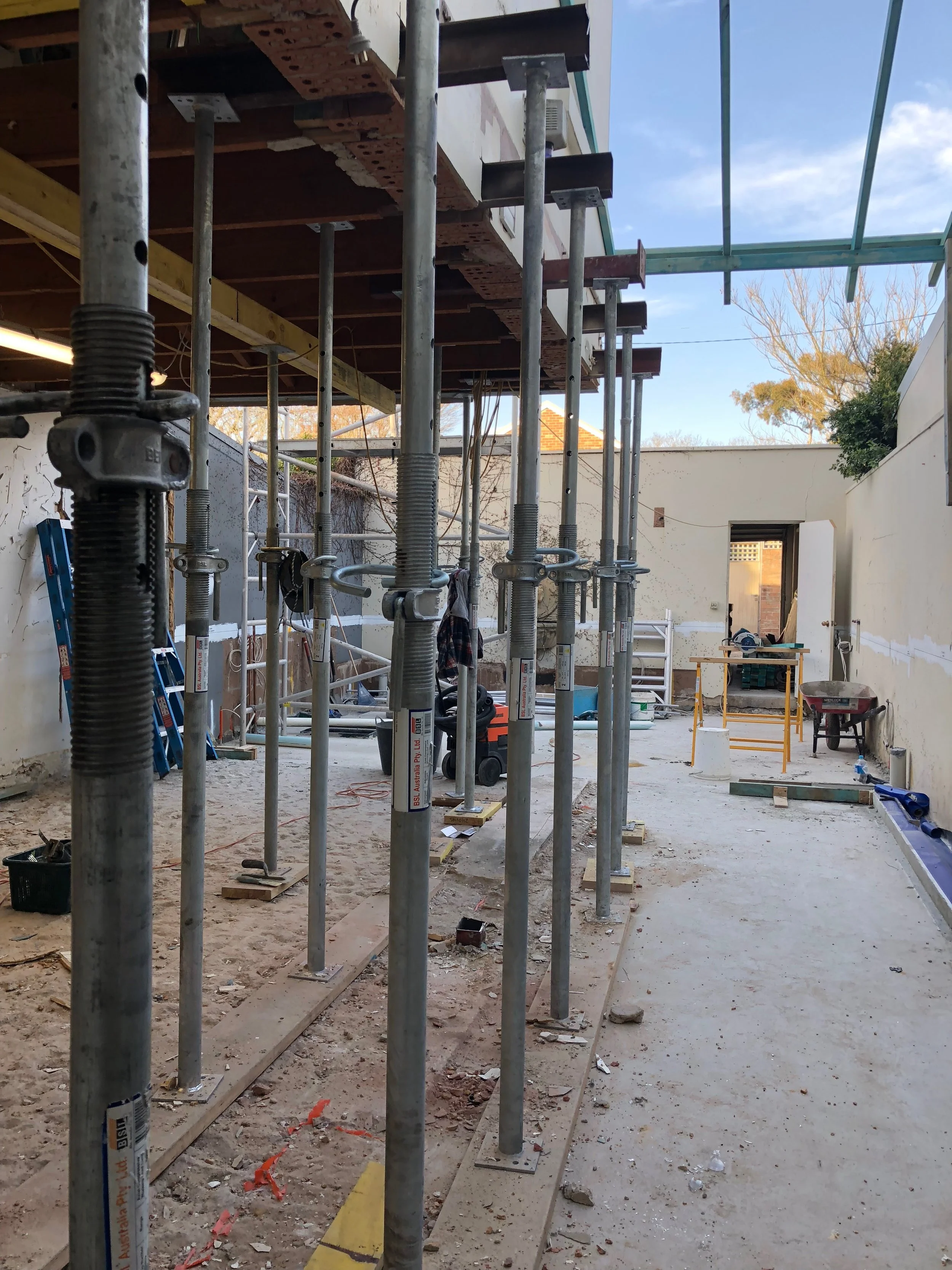 Today, part of the house is temporarily suspended above the ground by a forest of steel pillars.