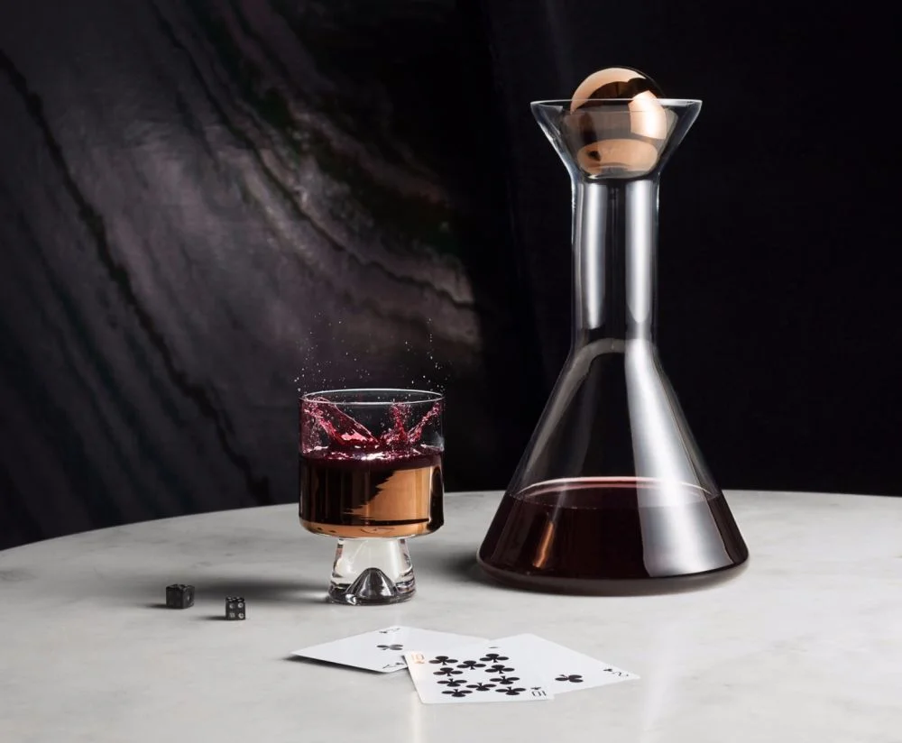 Design excellence on your table top, this Tom Dixon decanter (and matching low ball glasses) would look as striking filled with your finest wine as it would adorning your credenza. And in hand painted copper, of course…!