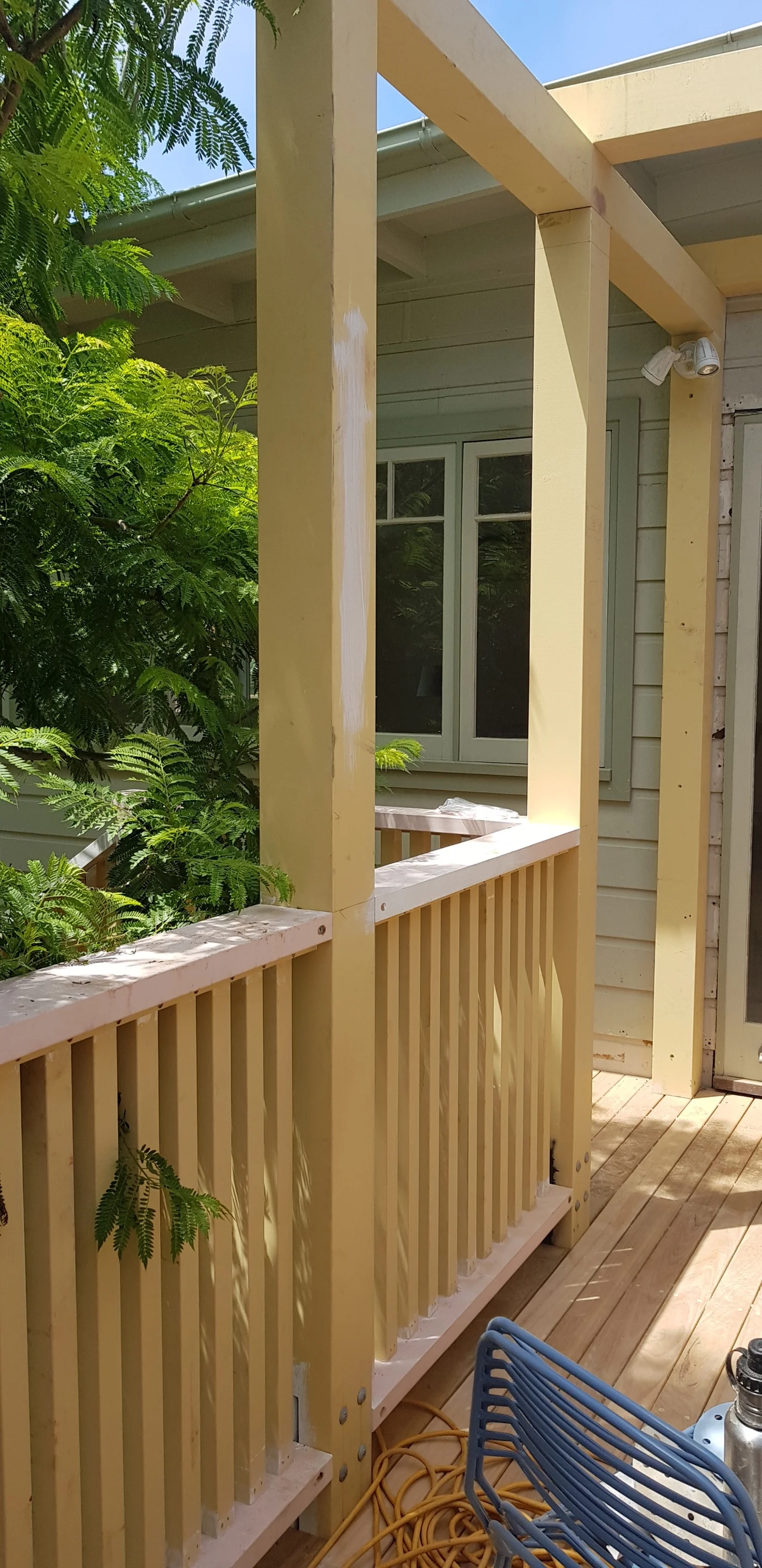 The pergola is to be painted a fresh white to contrast against the green landscaping.