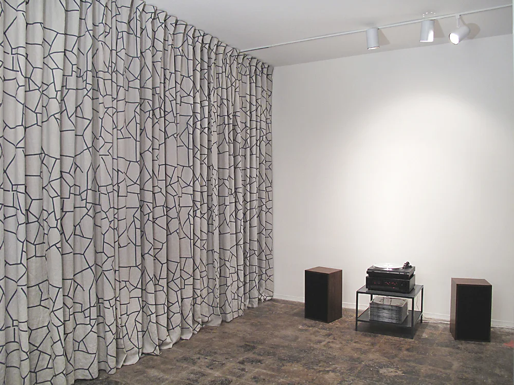   Rockslide Rocksolid , 2010: Installation view, Optical Project, Houston, TX.  Listening room with hand-printed linen sound curtains, custom furniture and original audio on limited edition vinyl records. 