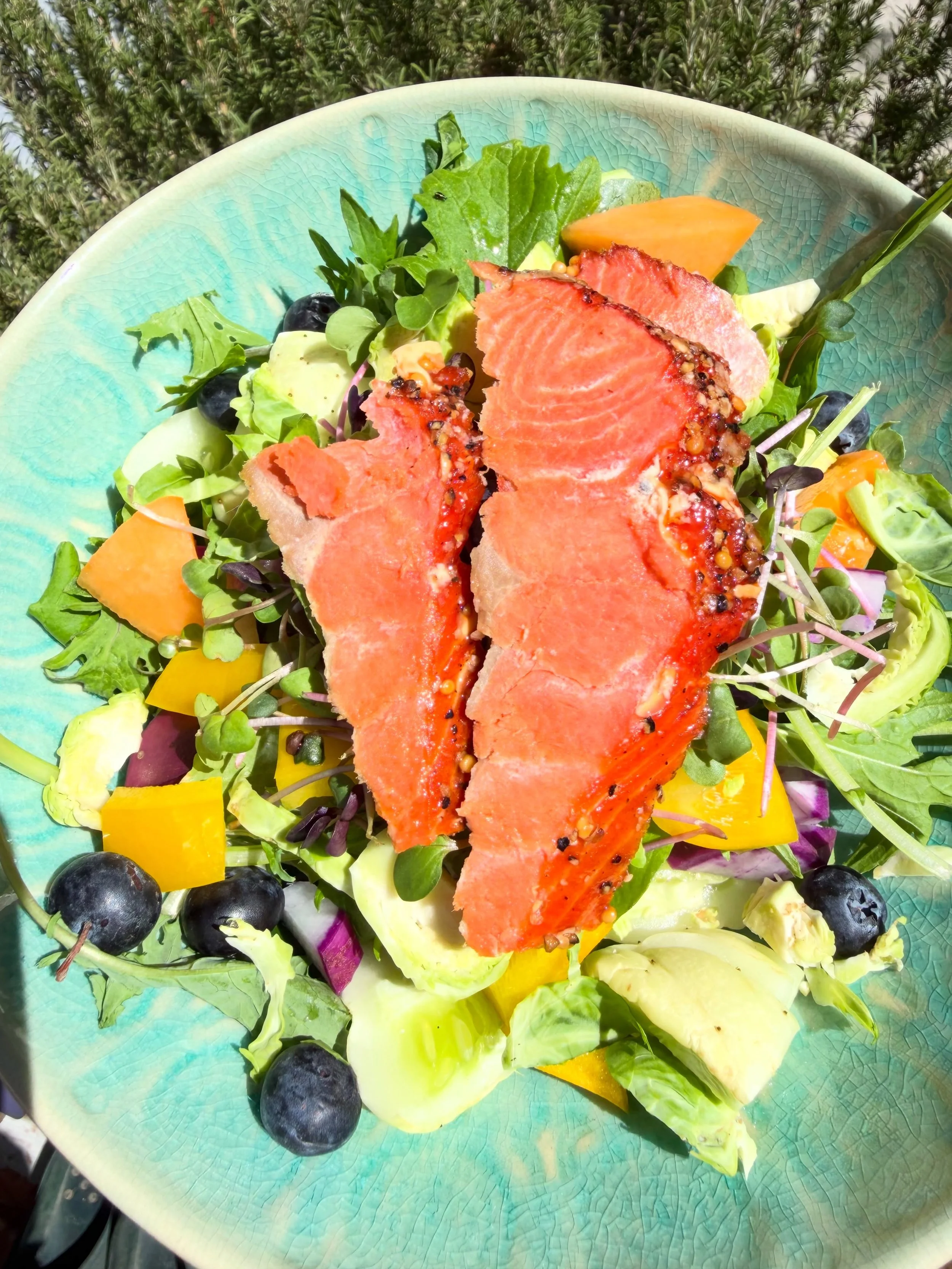 An easy lunch of mixed greens and purple daikon radish  from @theblueheronproject with other fun goodies thrown in including wild smoked salmon from TJs. A simple dressing of @pasture_42 olive oil, garlic, mustard, herbs and lemon juice made perfecti