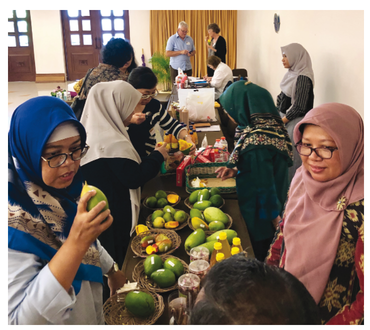 Workshop attendees sampling different mango varieties and products.