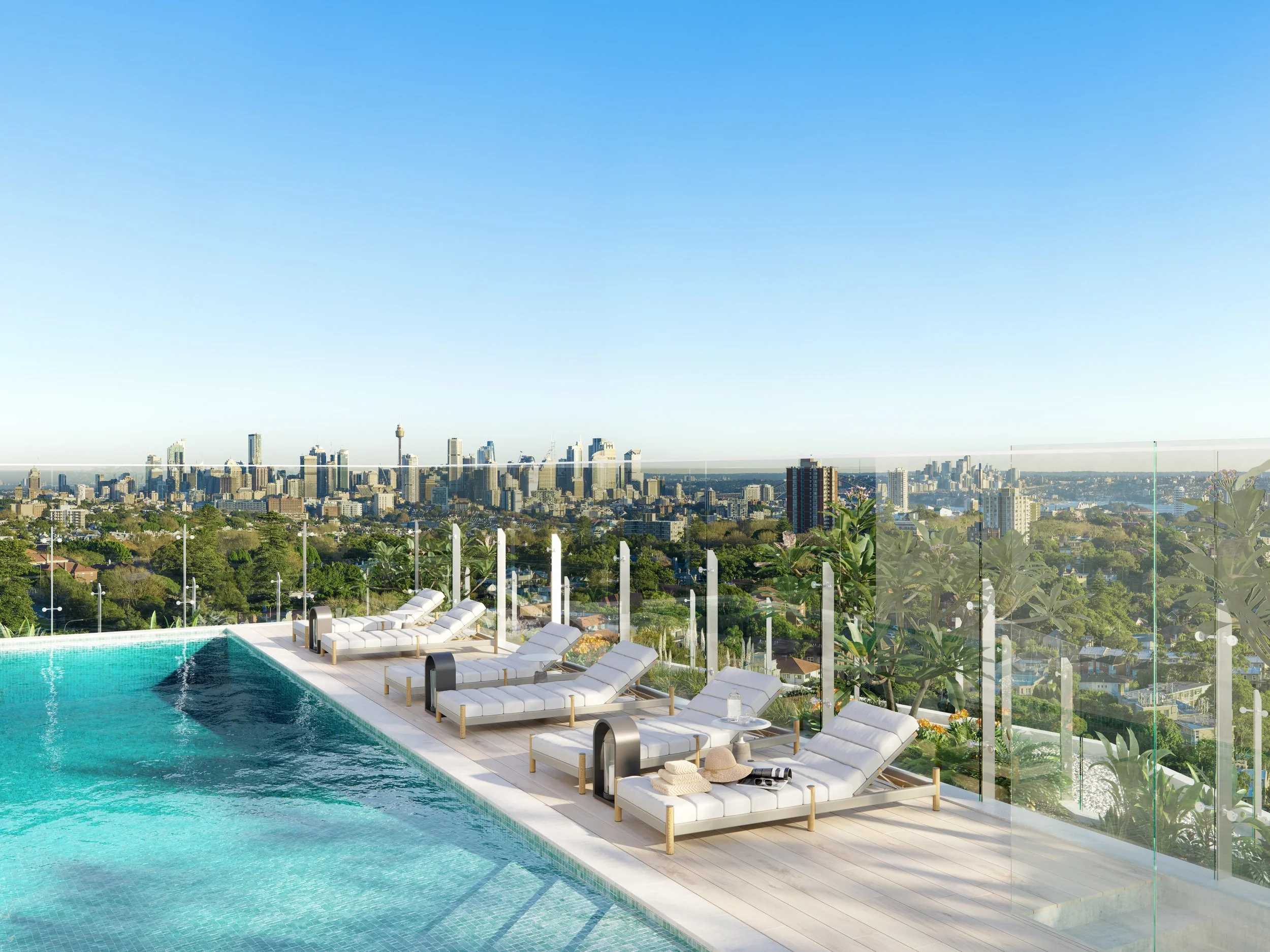 City skyline view from a rooftop pool area with lounge chairs and glass safety barriers.