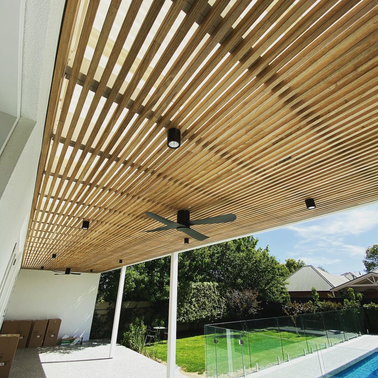 Black surface spots &amp; black fans on this awesome timber lined pergola #electrician #electricianlife #lightingtrendz #adelaide #pergolalights