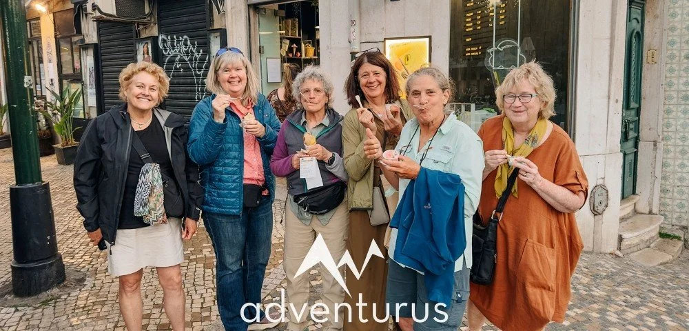 A group of female travelers eating ice cream in Portugal as part of the adventure trip organized by AdventurUs.