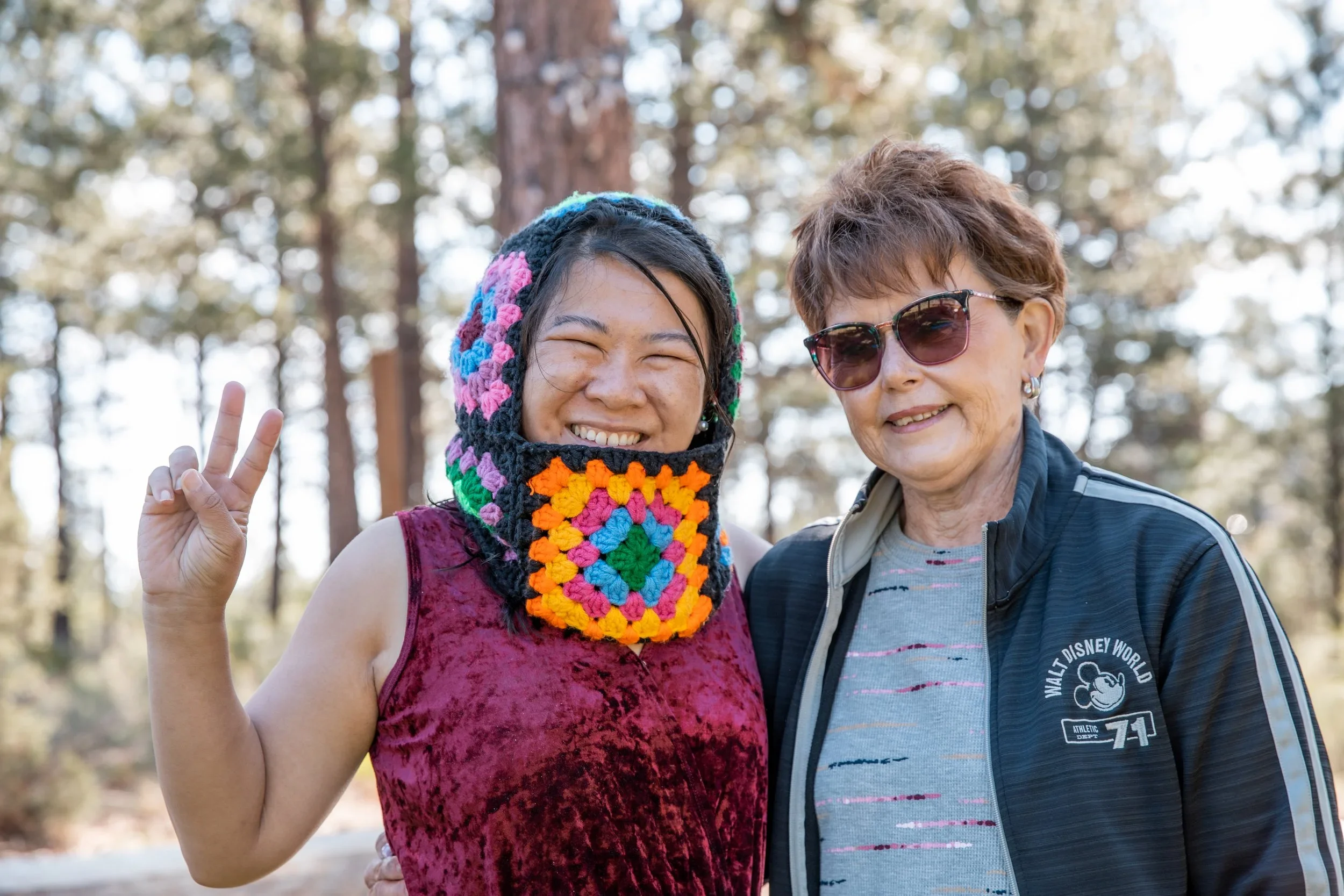 Song, on left, smiling outdoors with a new friend during the AdventurUs 2023 Bend Escape weekend.