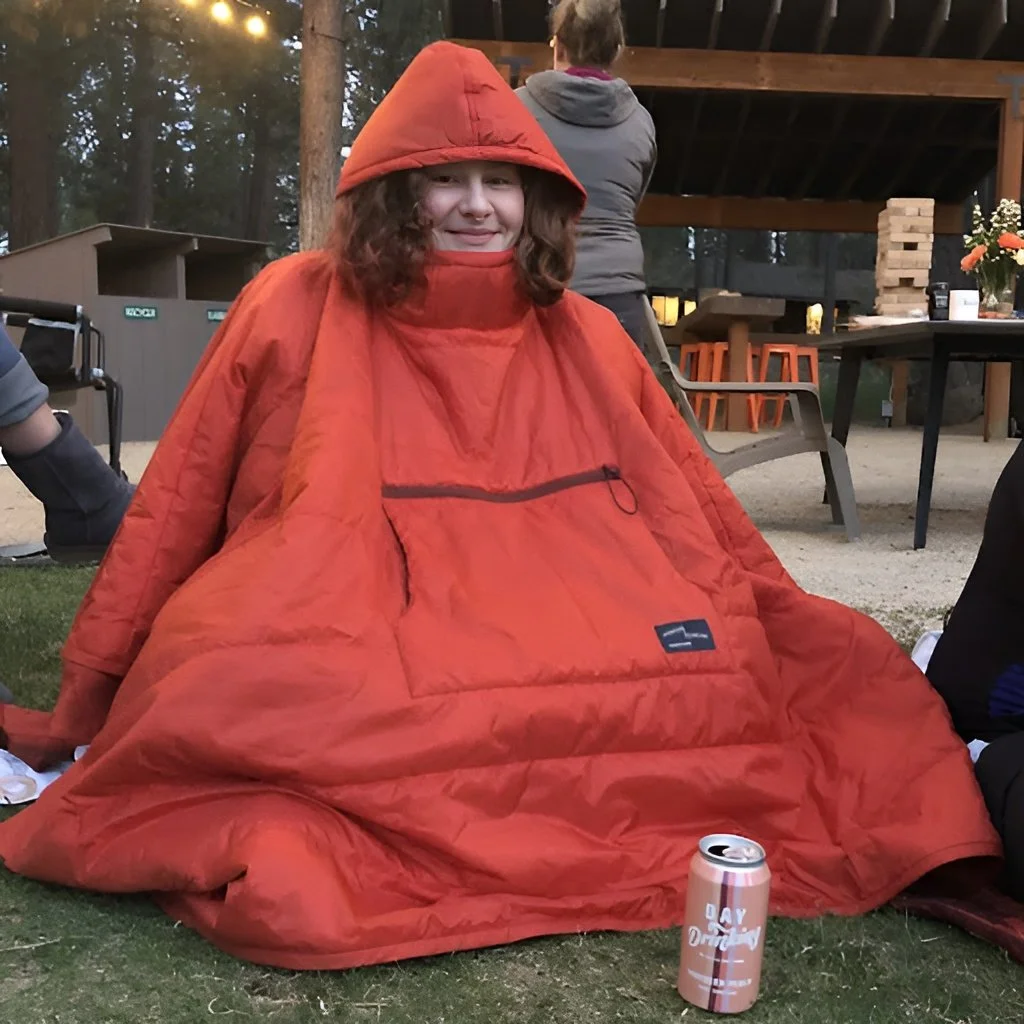 Elle is seated at the campsite organized by AdventurUs.