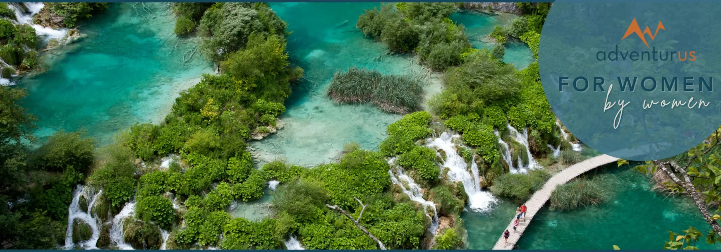 Aerial view of turquoise lakes and waterfalls with visitors walking on a wooden boardwalk promoting AdventurUs women led adventure travel experiences