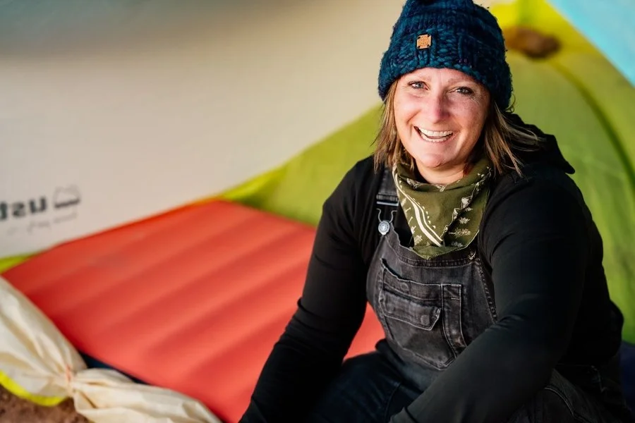 Becky Marcelliano posing for a picture while being inside a tent.