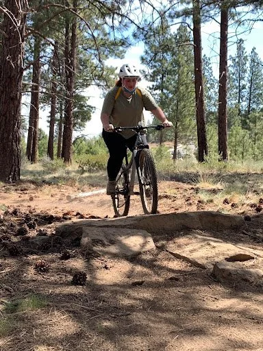 A woman riding the bike at the camp organised by AdventurUs.