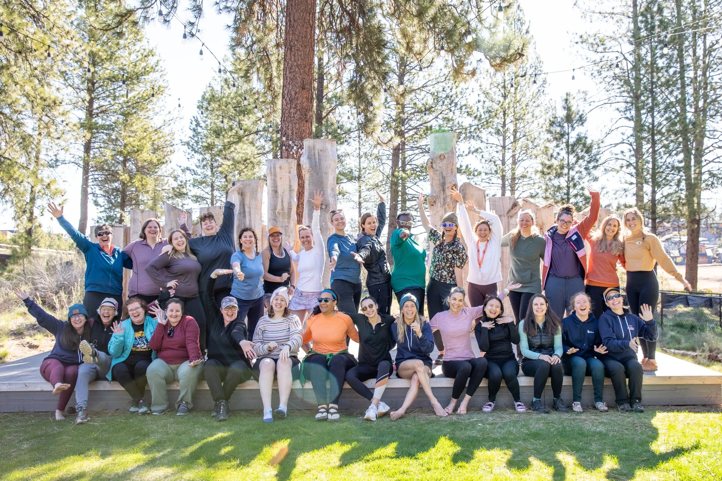 A group picture of women part of the AdventurUs Bend Adventure Camp posing for a picture.