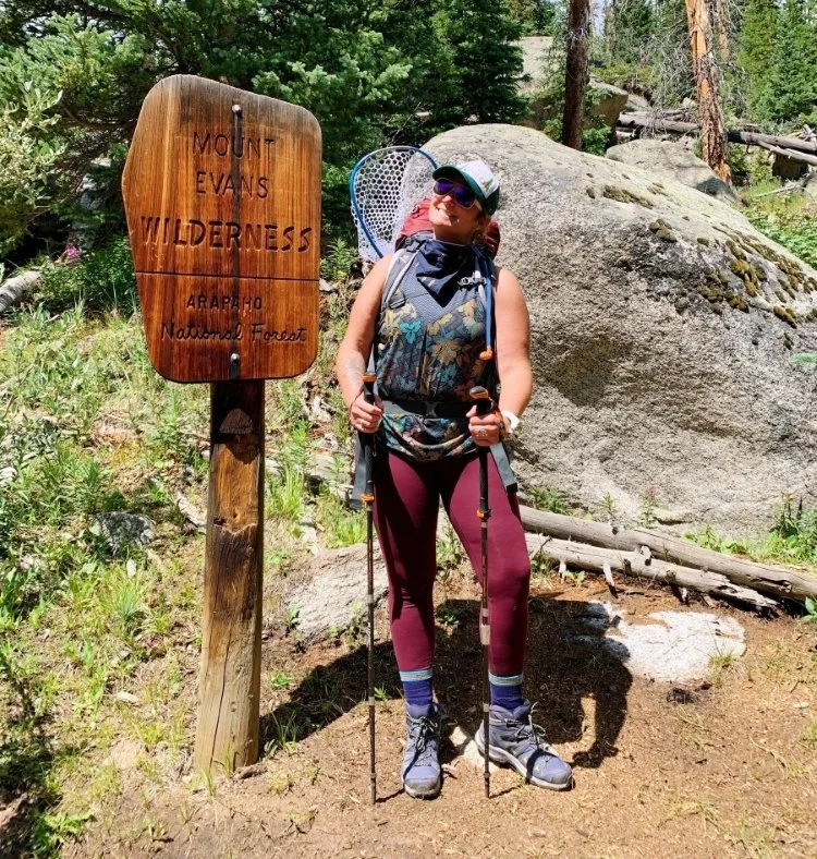 Becky Marcelliano posing for a picture during a hike.