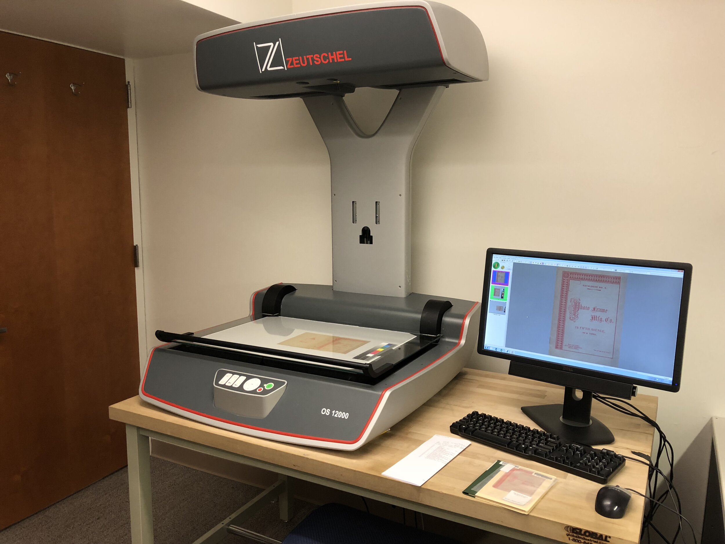   A Zeutschel OS 12000 scanner used for digitizing books and other collection materials in the Thomas J. Watson Library. Here, a custom "Pamphlet" setting is being used when digitizing     Photo Frame Mfg. Co.     (New York: Photo Frame Mfg. Co., ca.