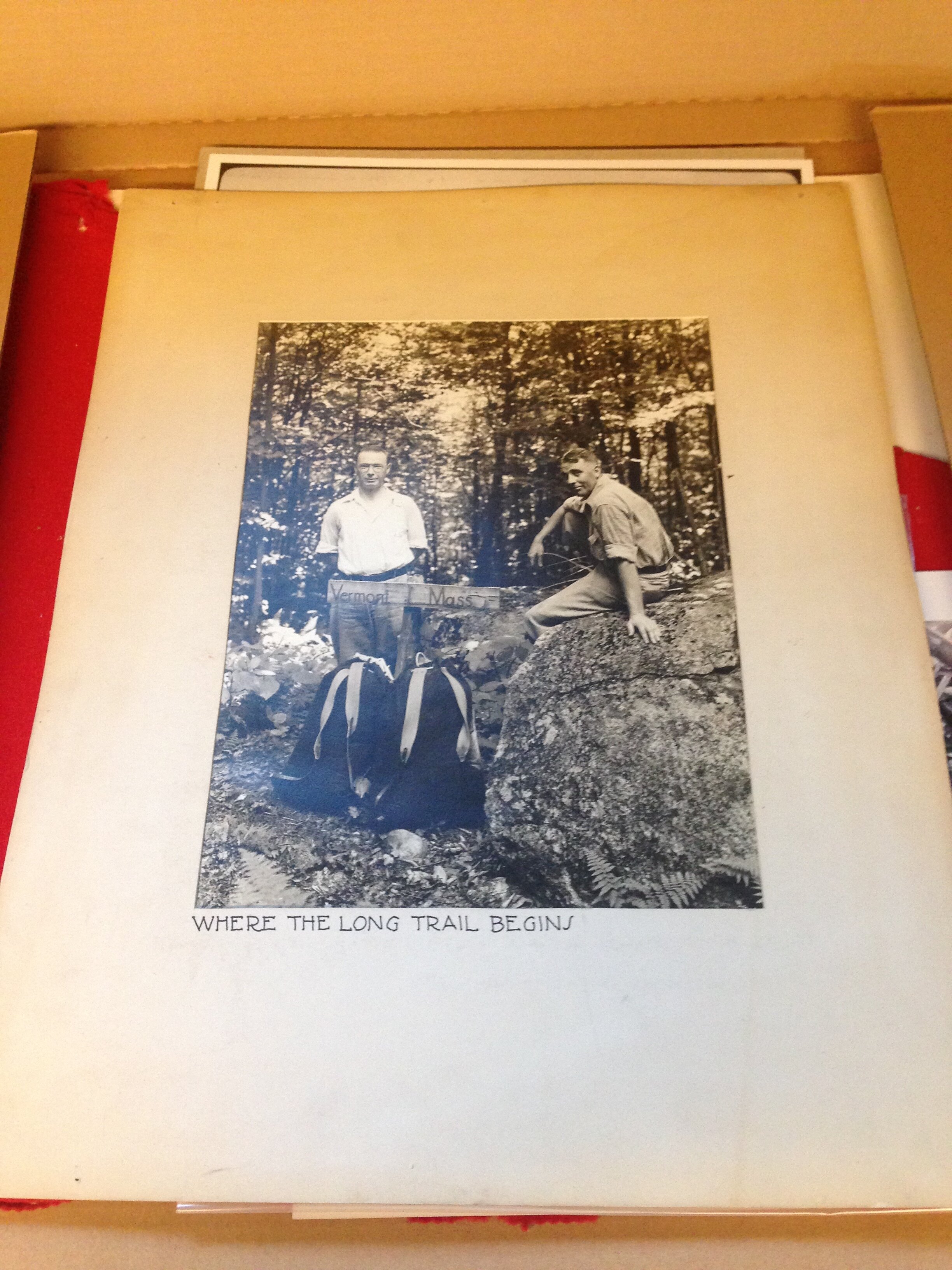   Photographic print of two hikers at the southern terminus of the Long Trail. The caption reads “Where The Long Trail Begins” (Green Mountain Club Archives).  