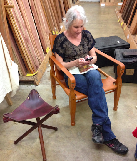 Mrs. Dowd managing Dowd Tools' social media reclining in Jason's Roorkhee chair