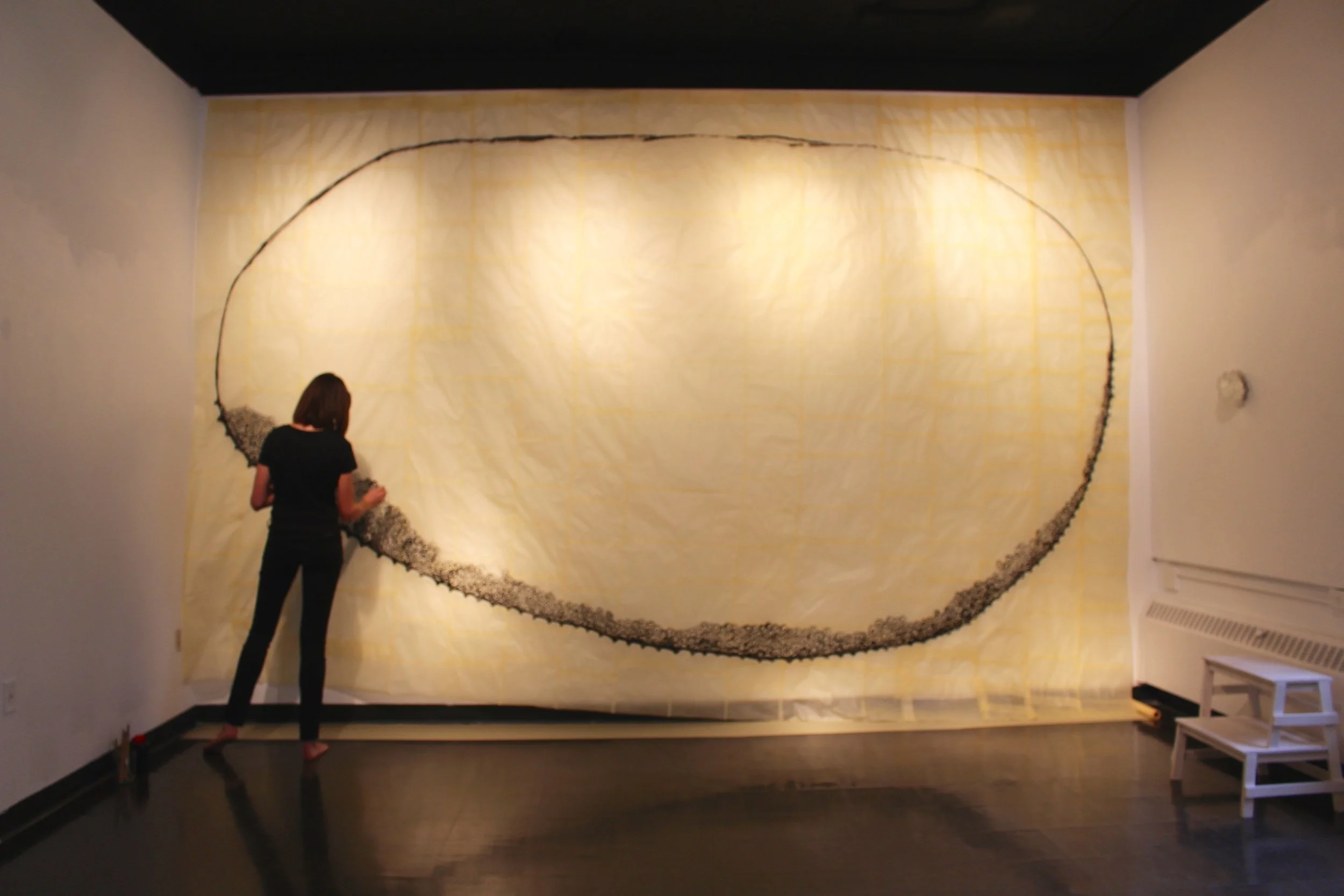 “_______ work” is a six-hour endurance performance drawing and installation I executed at the Vergette Gallery, Southern Illinois University in the fall of 2016. The installation included a paper I patch-worked together from tracing paper and wheat paste to the specific dimensions of the far wall of the gallery, 10 x 13 feet, three blown glass sculptures mounted to the walls of the gallery, and an armchair. Documented by performance attendees.