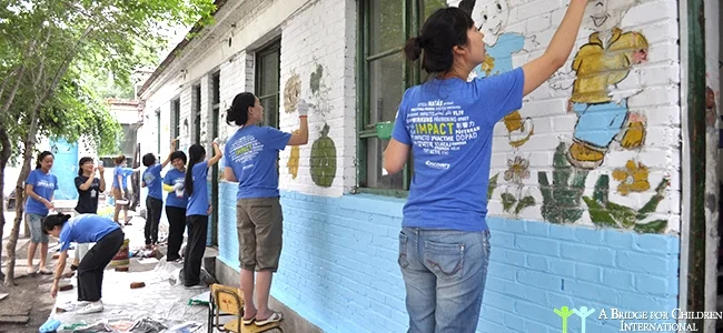 Discovery Channel volunteers painting schools at a migrant elementary school. 