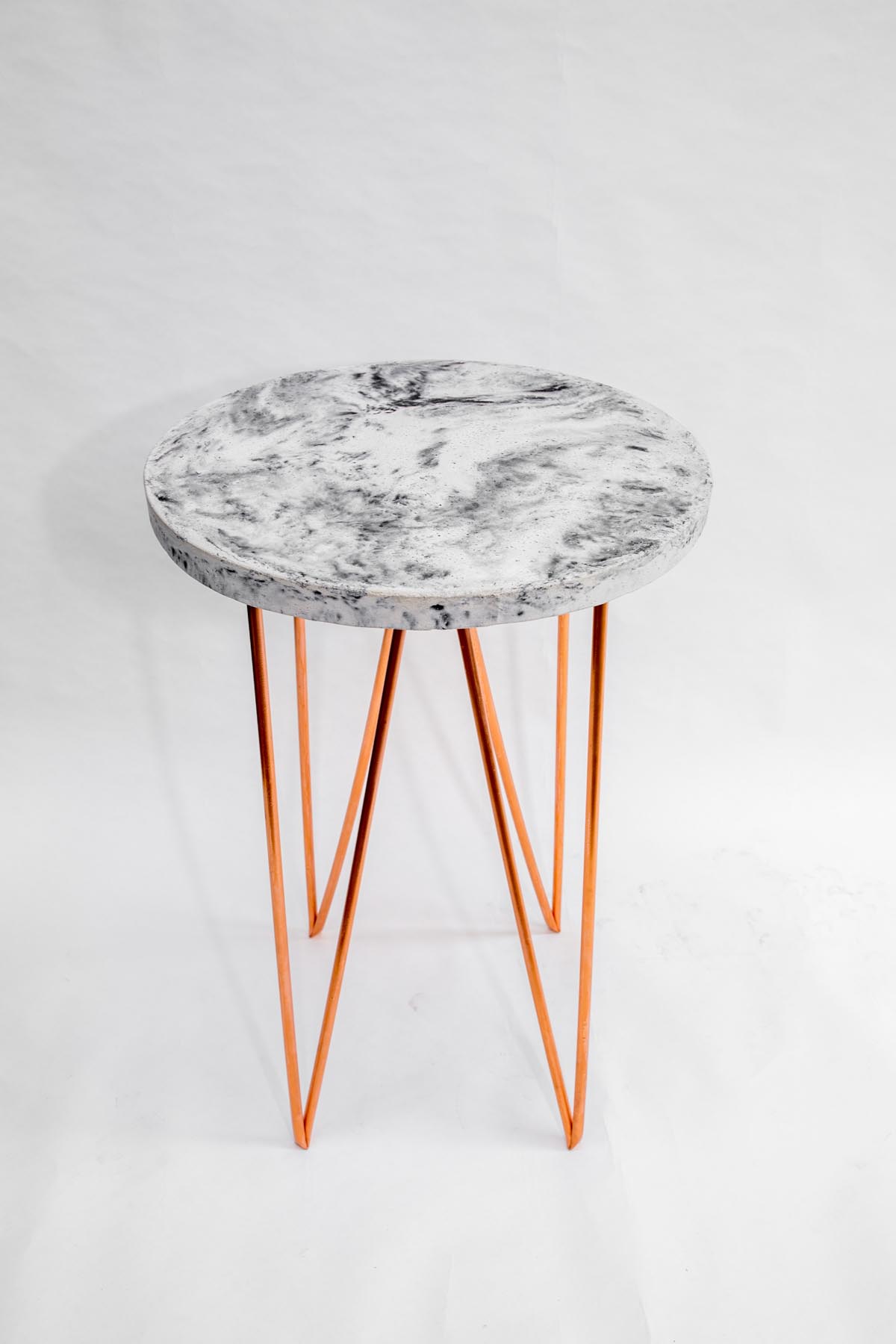 Vincent-Buret-Round-concrete-side-table-copper-legs-art pharmacy.jpg