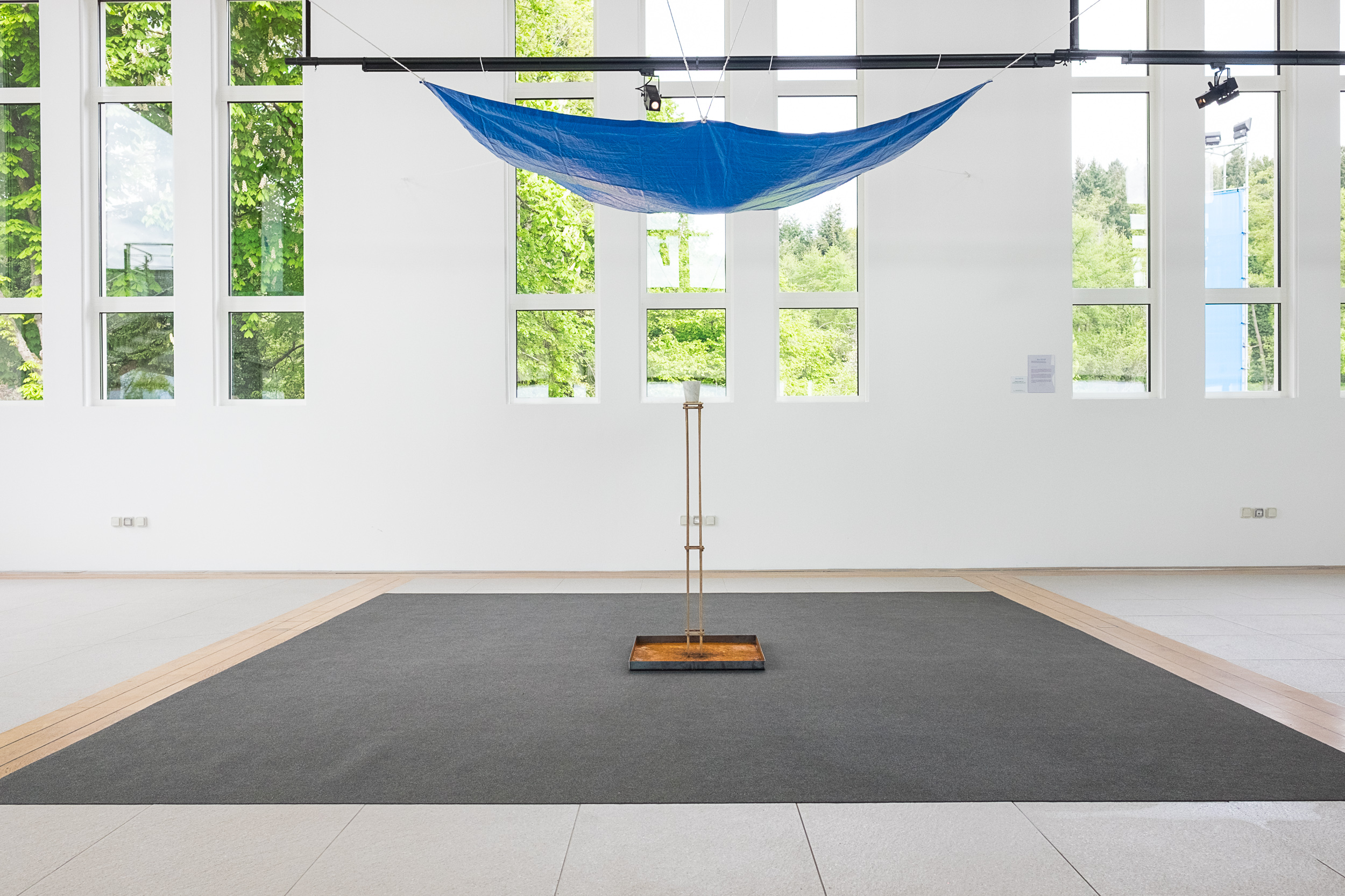    Deluge in a Cup   2015 Bianca Carrara, stainless steel tray, tarp, water, rope, Tasmanian oak stand Dimensions variable 