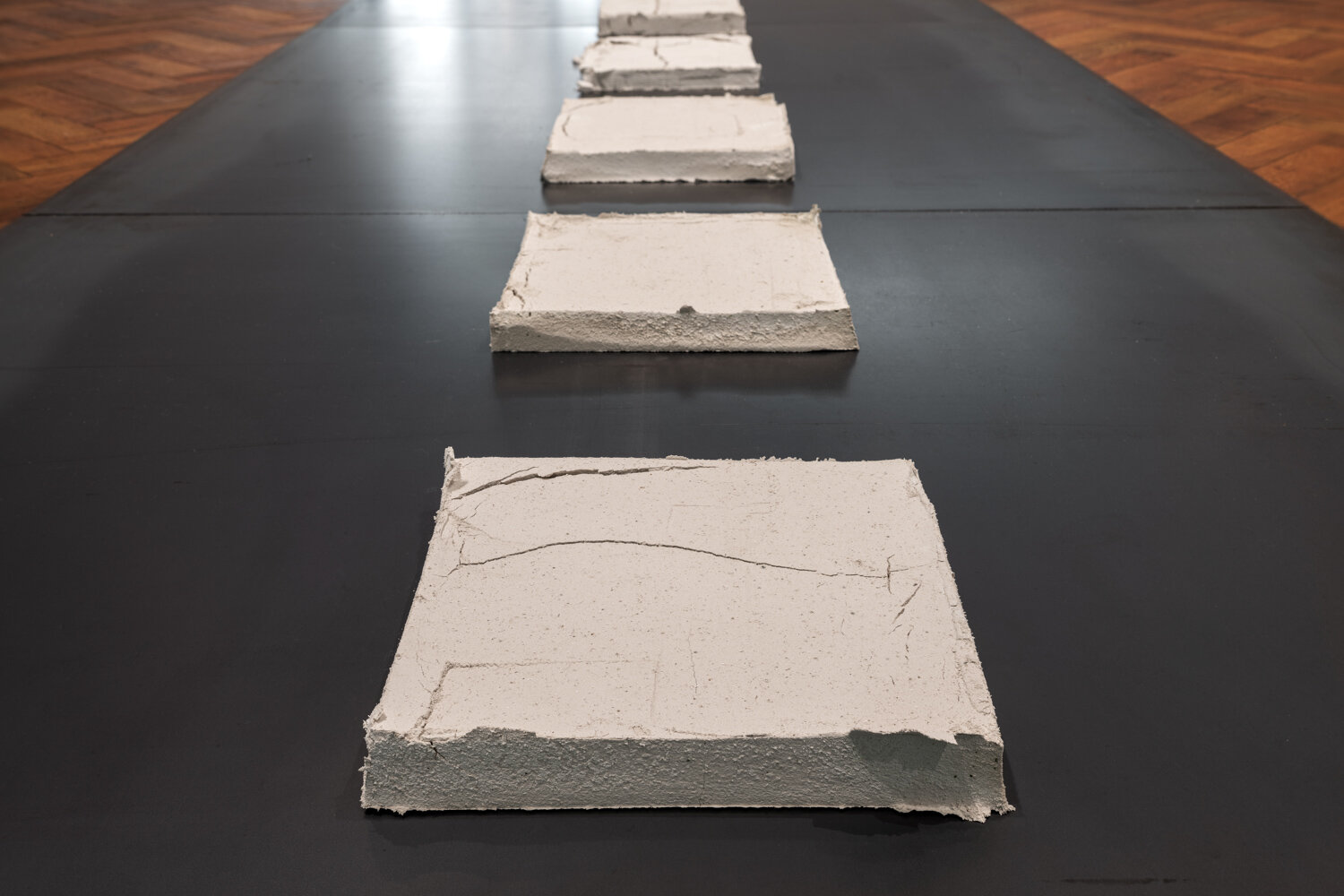  ‘The Track’ (2020). Calcium Oxide (Quicklime) tiles, stainless steel 10 x 720 x 120cm. Photo: Mark Pokorny.   